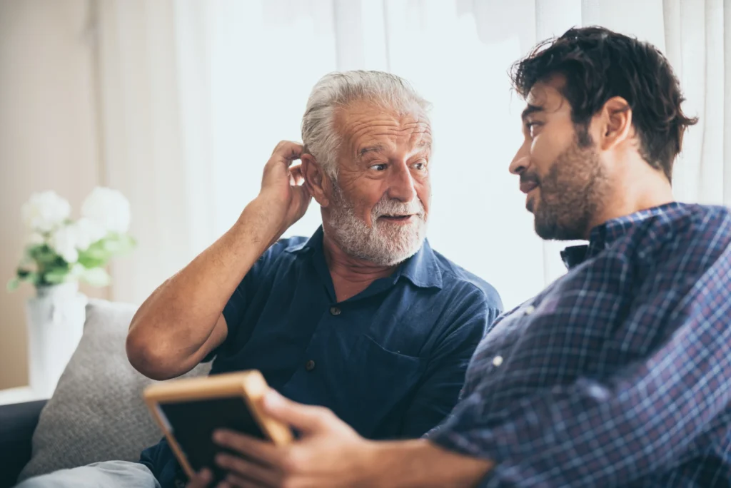 Father and son on sofa - Planning for retirement at Futures Assured with trusted expert financial advice