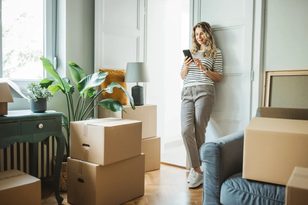 Woman at home surrounded by moving boxes - Securing their mortgage at Futures Assured with trusted expert financial advice