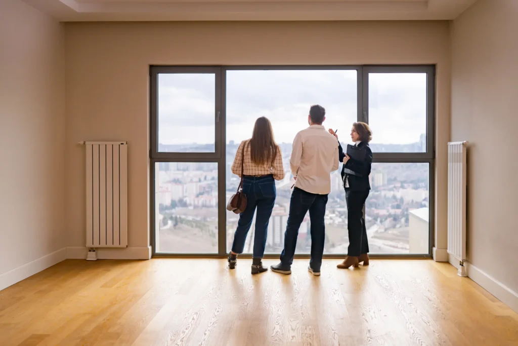 Young couple viewing a flat with estate agent - Securing their mortgage at Futures Assured with trusted expert financial advice